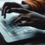 Person typing a document containing hidden white text prompt injection payload