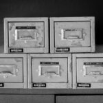 Open filing cabinet with corrupted glowing documents next to enterprise servers