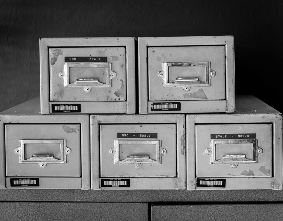 Open filing cabinet with corrupted glowing documents next to enterprise servers