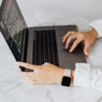 Person typing adversarial prompt into an AI chat interface on laptop