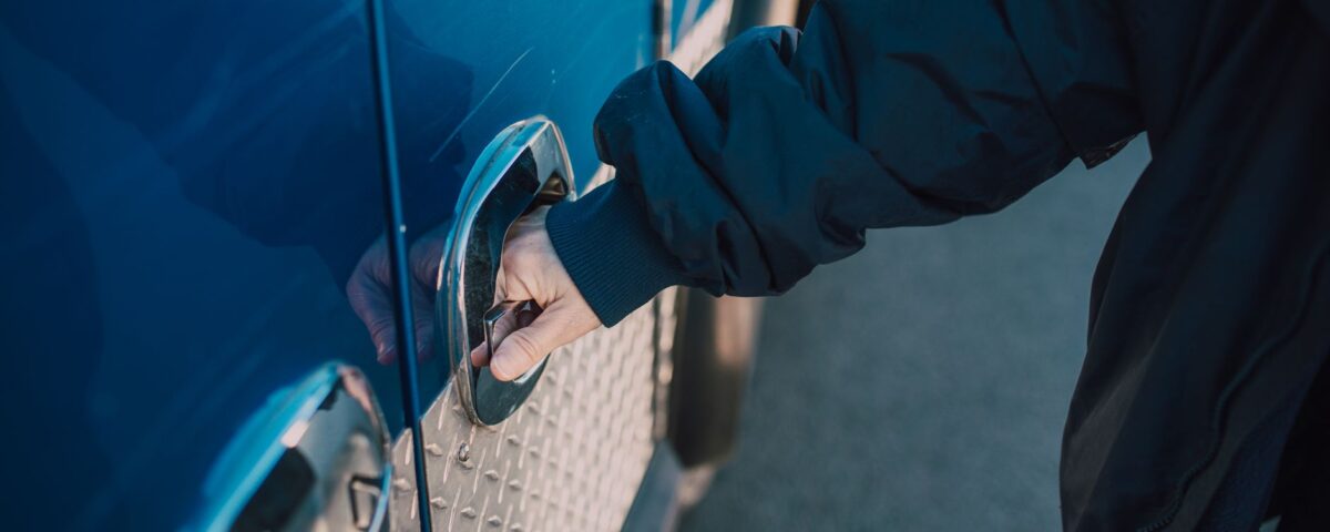 Gloved hand bypassing a reinforced security lock on metal gate