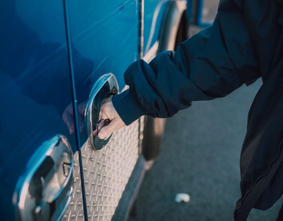 Gloved hand bypassing a reinforced security lock on metal gate