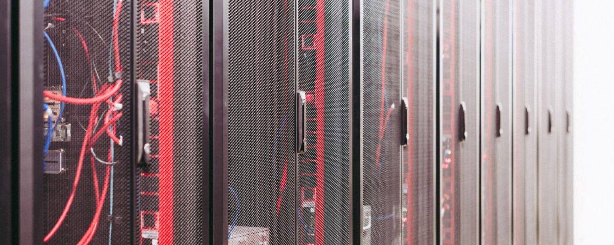 Network engineer inspecting server rack cables in a data center