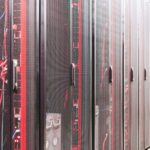 Network engineer inspecting server rack cables in a data center