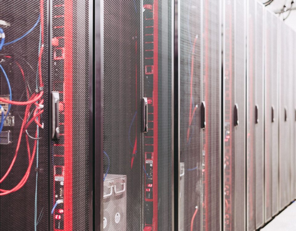Network engineer inspecting server rack cables in a data center