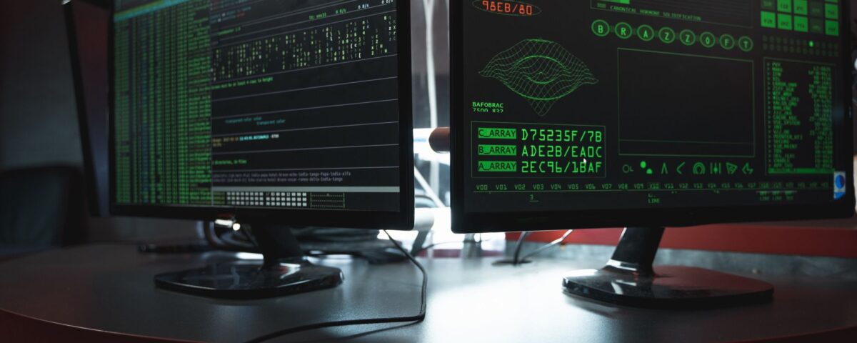 Developer reviewing AI-generated code with security warnings on dual monitors
