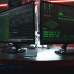 Developer reviewing AI-generated code with security warnings on dual monitors