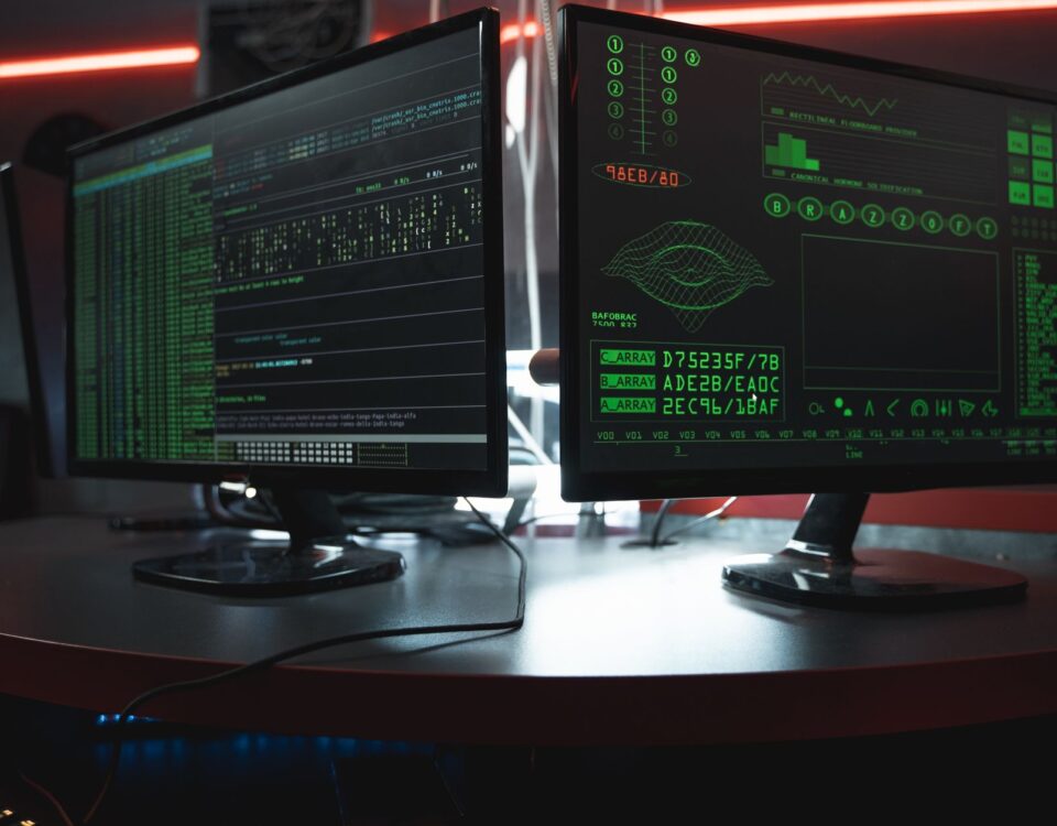 Developer reviewing AI-generated code with security warnings on dual monitors