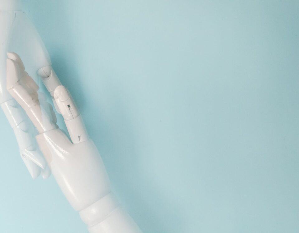 Two robotic arms exchanging a glowing digital document on an assembly line