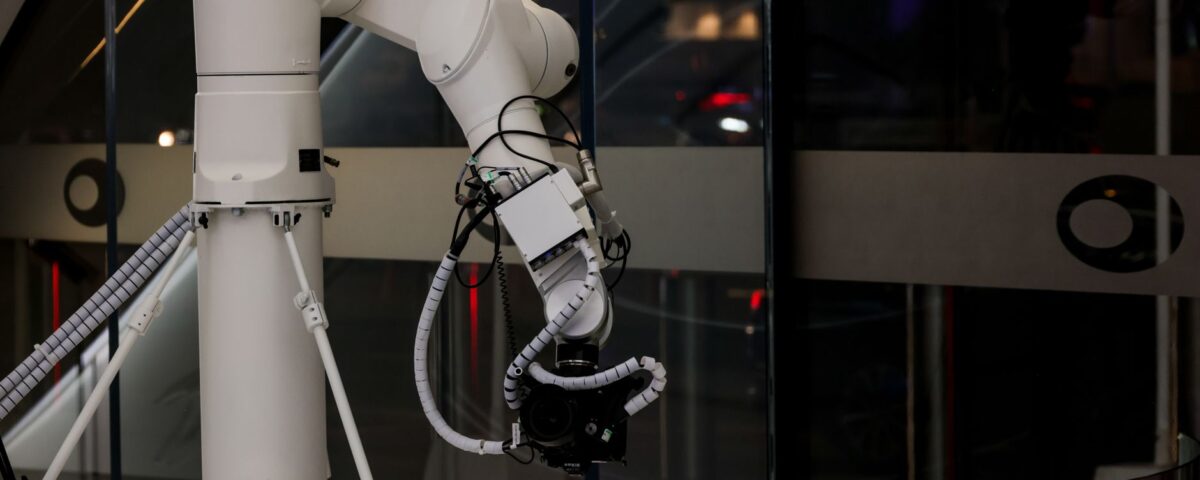 Robotic arm pressing keyboard keys in a dark server room