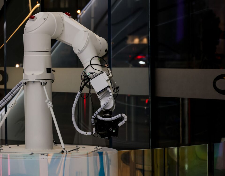 Robotic arm pressing keyboard keys in a dark server room
