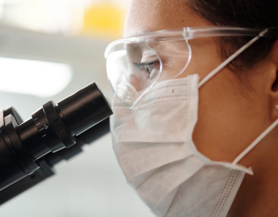 Researcher examining glowing brain scan data on laboratory monitor screen