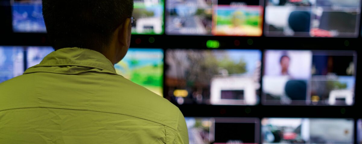 Security analyst monitoring identity access graphs and risk dashboards at workstation