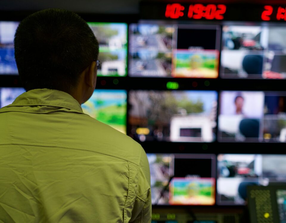 Security analyst monitoring identity access graphs and risk dashboards at workstation