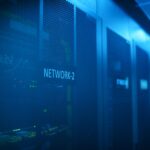 Security analyst reviewing cloud threat alerts in a server room