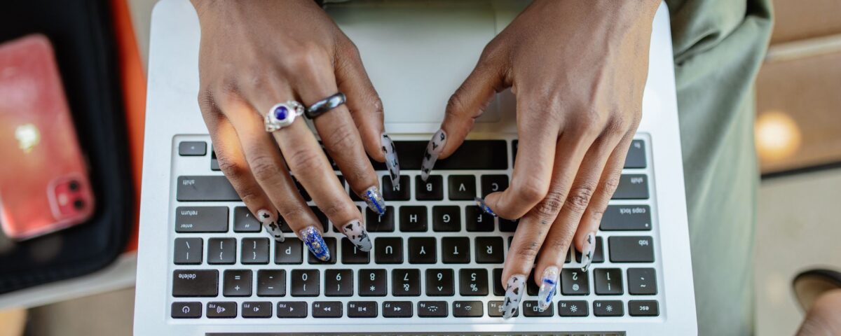 Professional typing on laptop with behavioral biometric session monitoring overlay