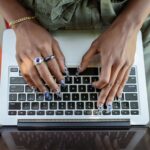 Professional typing on laptop with behavioral biometric session monitoring overlay