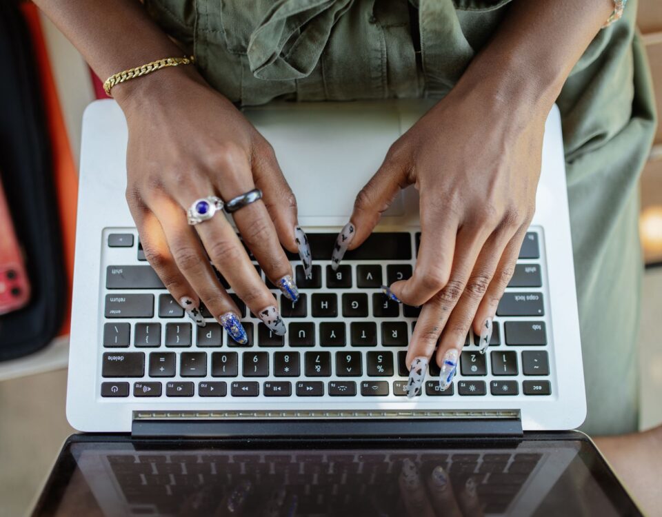 Professional typing on laptop with behavioral biometric session monitoring overlay