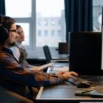 Security analyst reviewing AI pipeline code logs on dual monitors