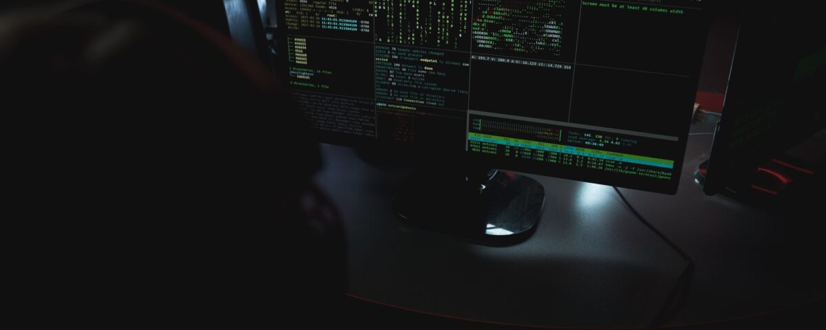 Security analyst reviewing autonomous AI agent audit logs on terminal screens
