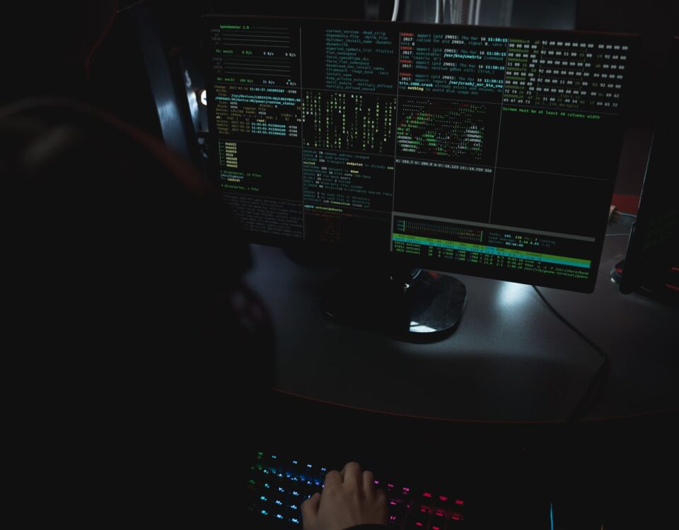 Security analyst reviewing autonomous AI agent audit logs on terminal screens