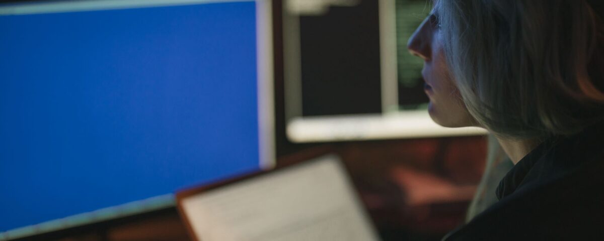 Security analyst reviewing AI-driven threat maps on multiple enterprise monitors