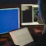 Security analyst reviewing AI-driven threat maps on multiple enterprise monitors