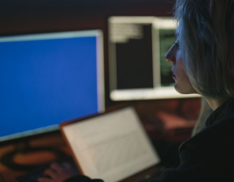 Security analyst reviewing AI-driven threat maps on multiple enterprise monitors