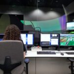 Security analyst reviewing AI agent action approval request on control room monitors