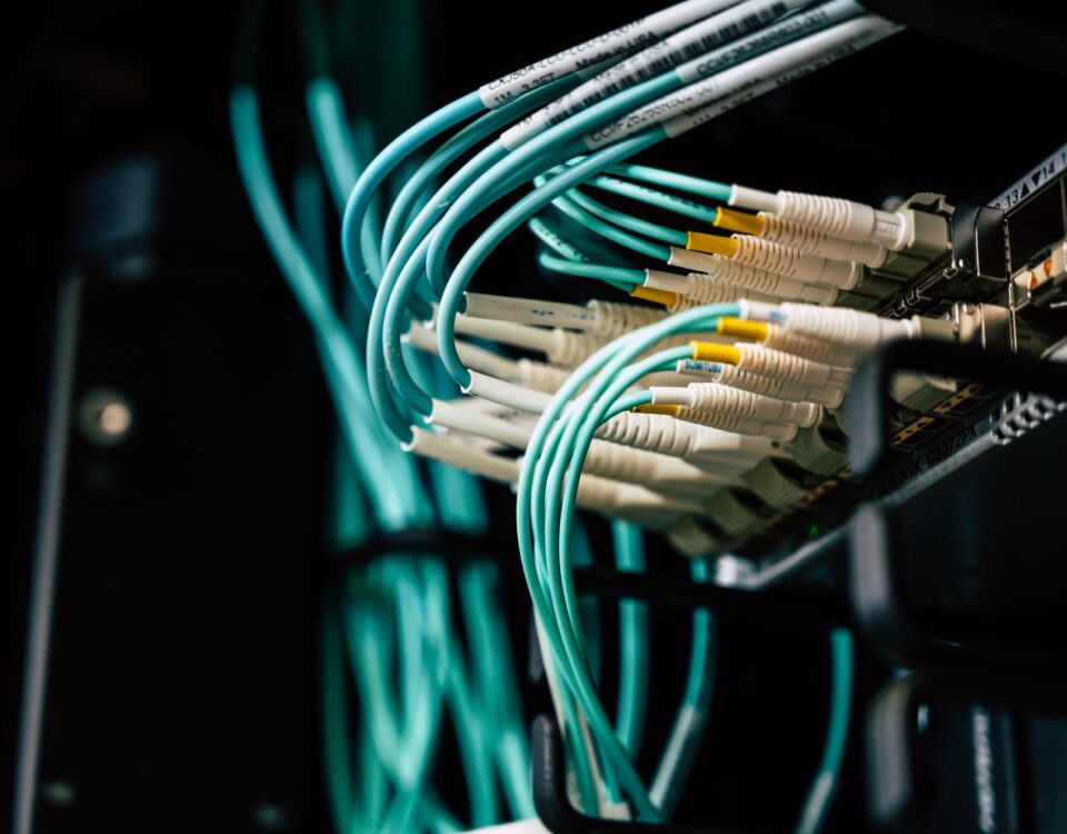 Technician inspecting open server rack in enterprise data center aisle