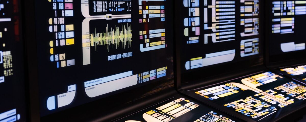 Enterprise server room monitoring screens displaying autonomous AI action logs