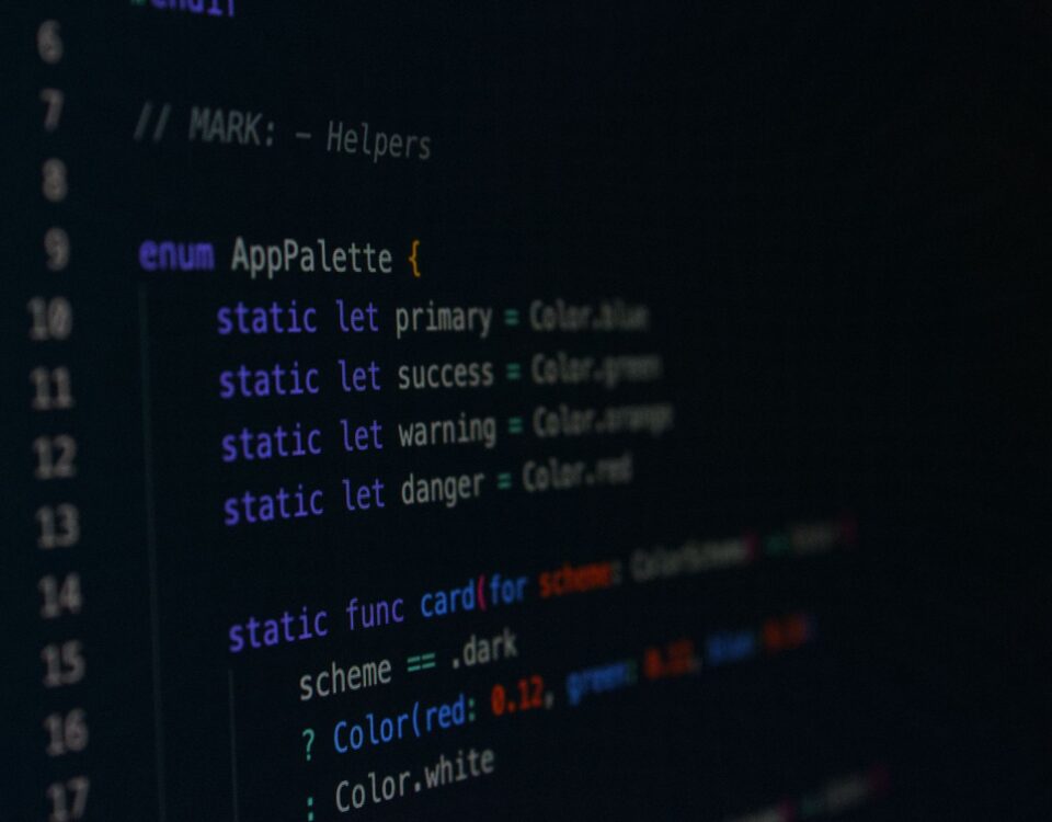 Developer reviewing software component dependency diagram on dual monitors