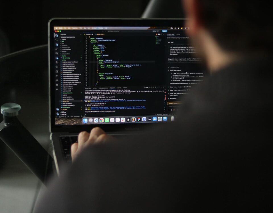 Security engineer reviewing AI plugin code on dual monitors in office