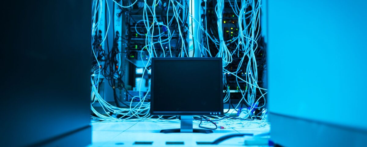 Robotic arm pressing keyboard key inside a secure server room