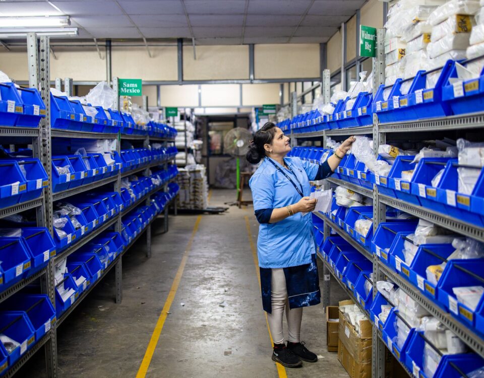 Technician inspecting labeled storage packages in a secure server room