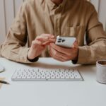 Business professional receiving a suspicious phone call at corporate office desk