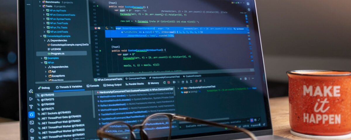 Laptop screen showing GitHub Actions YAML workflow configuration code terminal