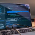 Laptop screen showing GitHub Actions YAML workflow configuration code terminal