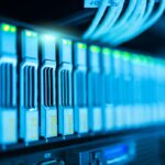 Enterprise data center server rack aisle with color-coded cable bundles