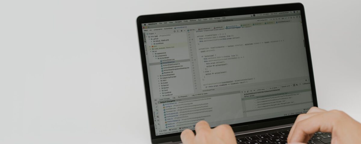Developer reviewing an open-source code pull request on laptop screens