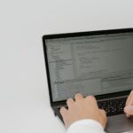 Developer reviewing an open-source code pull request on laptop screens