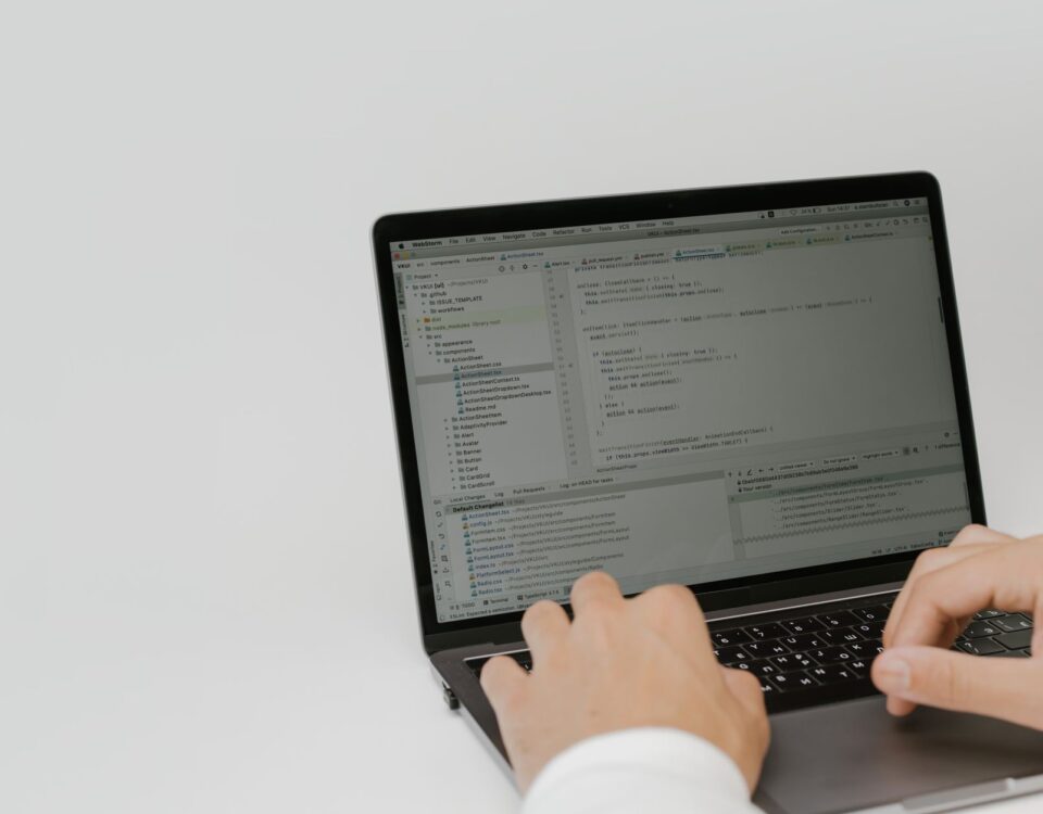 Developer reviewing an open-source code pull request on laptop screens