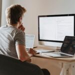 Developer reviewing SAST security scan results on code editor monitors