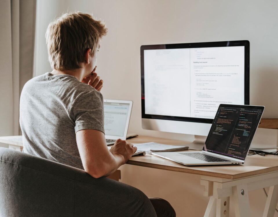 Developer reviewing SAST security scan results on code editor monitors