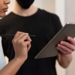 Person confirming transaction on a hardware cryptocurrency wallet device