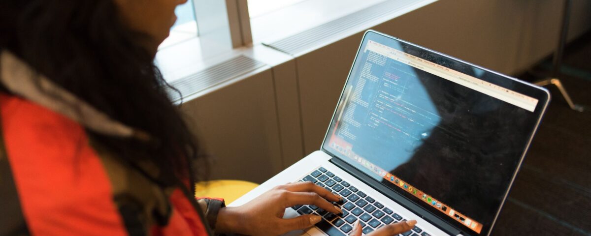 Developer typing a package install command in a terminal window on laptop