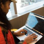 Developer typing a package install command in a terminal window on laptop