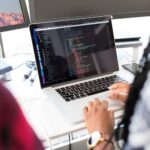 Developer laptop displaying code editor with security key attached