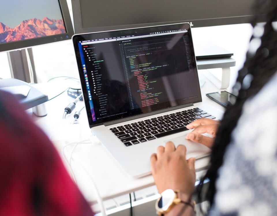 Developer laptop displaying code editor with security key attached